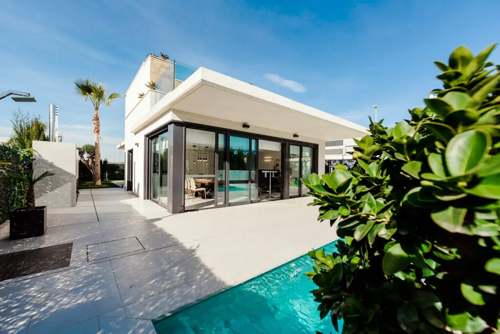 a house with a pool and trees