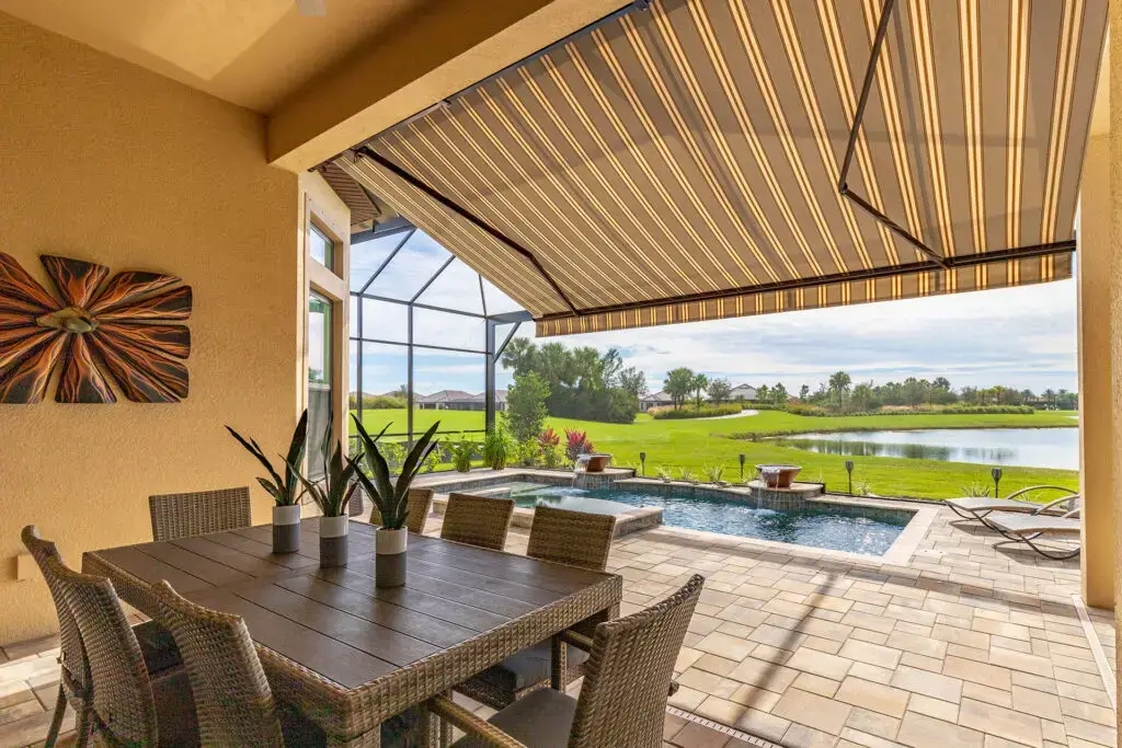 a patio with a pool and a table