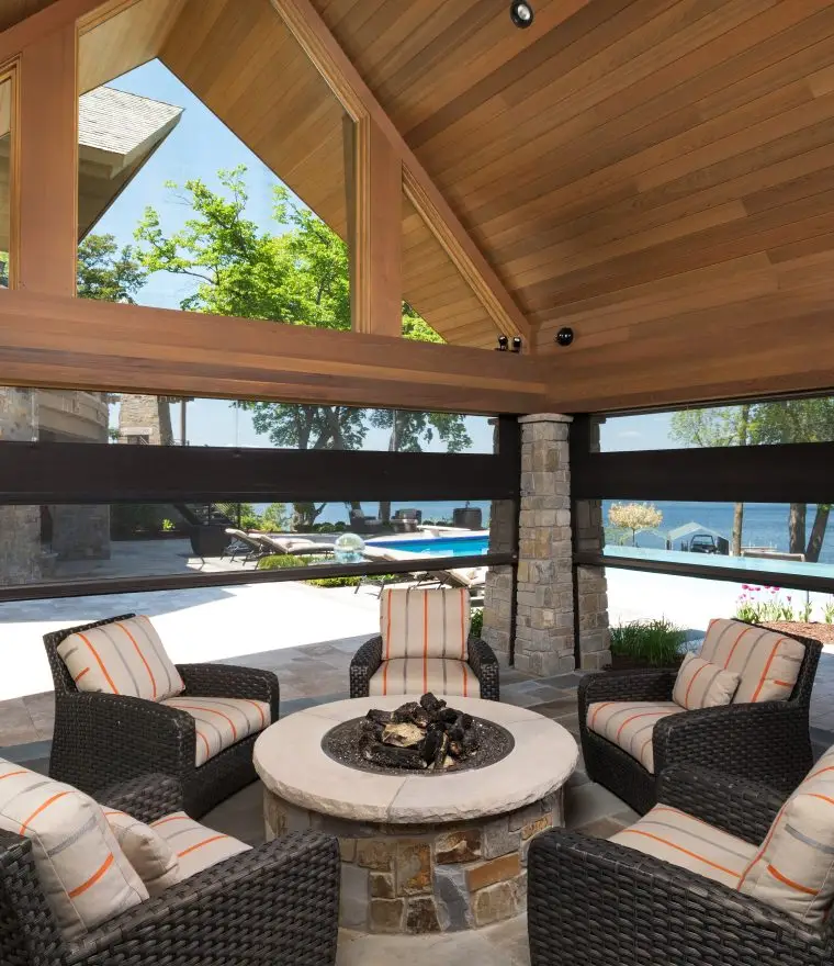 a patio with chairs and a fire pit