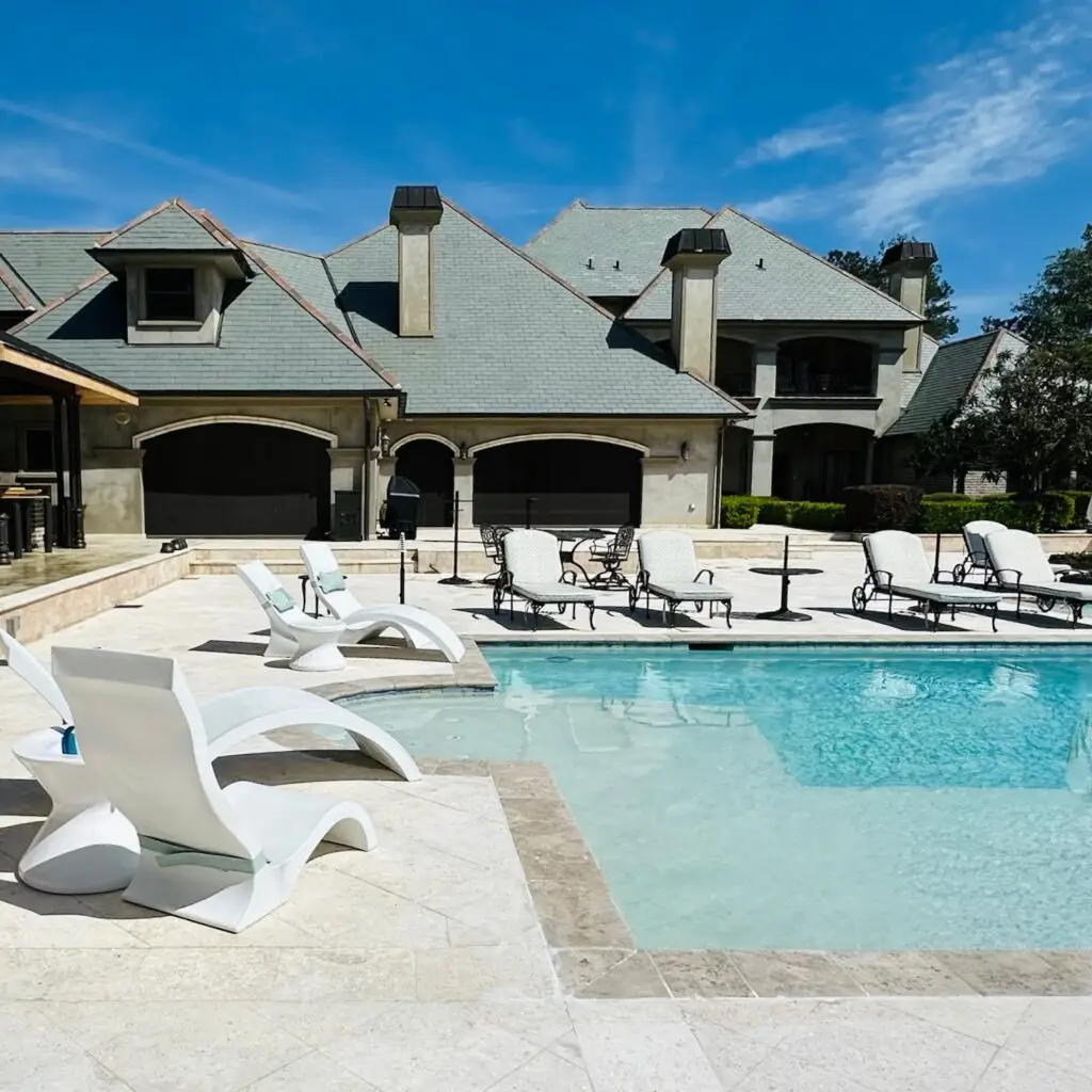 a beautiful backyard with retractable patio screens and a pool New Orleans Mandeville Covington Slidell Hammond